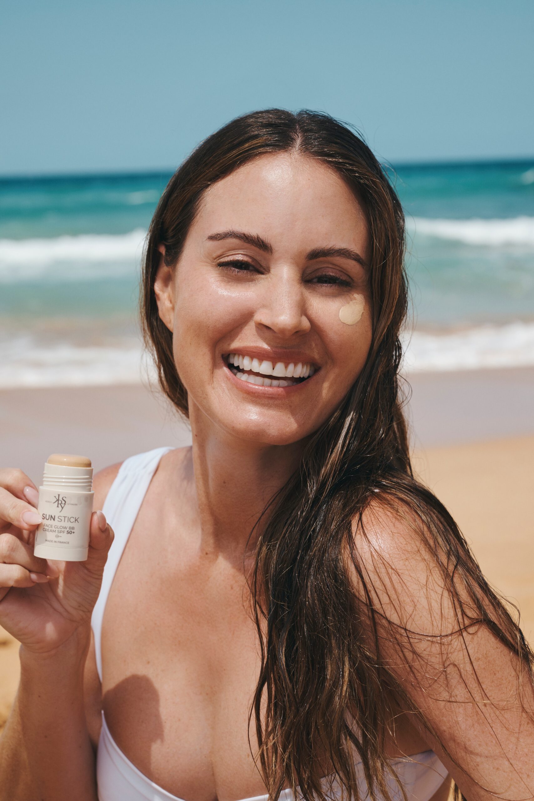 Frau am Strand mit KERSY SUN Sonnenpflegestick